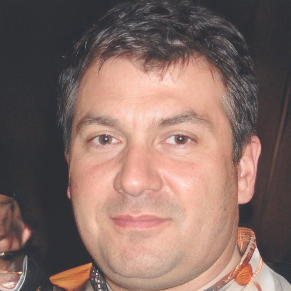 Risk management specialist reviewing financial reports and market analysis documents